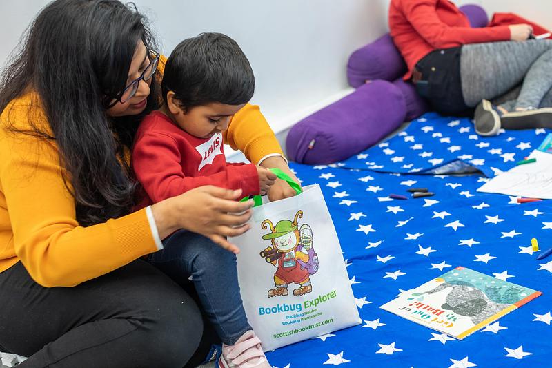 Image of mum and child looking at the Bookbug Explorer Bag together